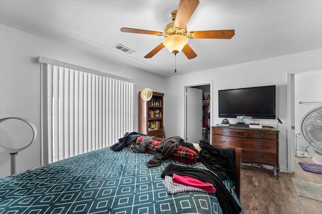 726 Stonebriar Trl, Redding, CA 96003 - bedroom featuring wood finished floors, a spacious closet, and ceiling fan