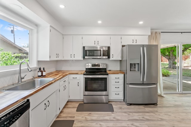 4135 Oro St, Redding, CA 96001 - kitchen featuring appliances with stainless steel finishes, tasteful backsplash, white cabinetry, and recessed lighting