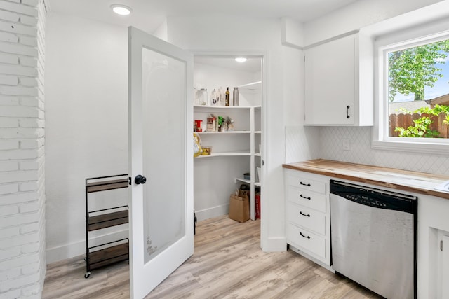 4135 Oro St, Redding, CA 96001 - kitchen with stainless steel dishwasher, light wood finished floors, backsplash, white cabinetry, and wood counters