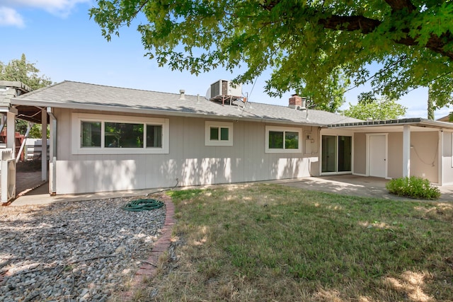 4135 Oro St, Redding, CA 96001 - back of property featuring a chimney, a lawn, and a patio area