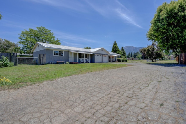 37153/55 Siskiyou St, Burney, CA 96028 - single story home featuring a garage, driveway, a mountain view, and a metal roof