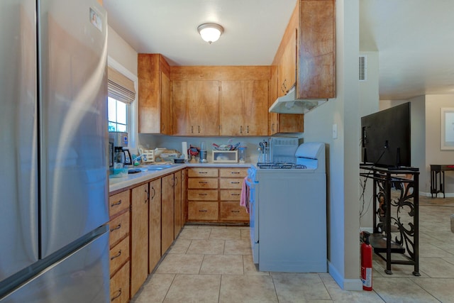 37153/55 Siskiyou St, Burney, CA 96028 - kitchen with freestanding refrigerator, white range with gas stovetop, under cabinet range hood, light countertops, and light tile patterned floors