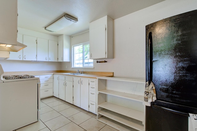 37153/55 Siskiyou St, Burney, CA 96028 - kitchen with freestanding refrigerator, gas range gas stove, white cabinetry, and light countertops