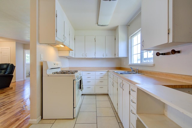 37153/55 Siskiyou St, Burney, CA 96028 - kitchen with white gas range, white cabinetry, light countertops, and light wood-style flooring