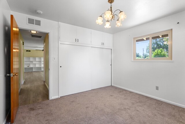 5858 Deschutes Rd, Anderson, CA 96007 - unfurnished bedroom with a chandelier, carpet flooring, and a closet