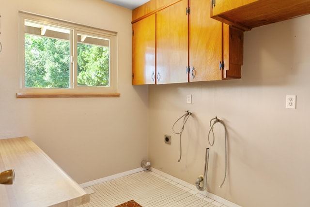 5858 Deschutes Rd, Anderson, CA 96007 - laundry room featuring cabinet space, hookup for an electric dryer, and tile patterned flooring