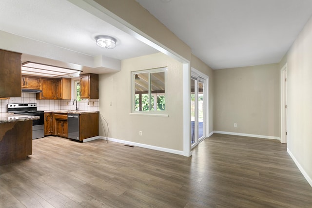 5858 Deschutes Rd, Anderson, CA 96007 - kitchen featuring appliances with stainless steel finishes, dark wood finished floors, tasteful backsplash, and brown cabinets