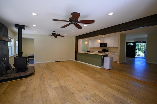 290 Mountain View Dr, Lewiston, CA 96052 - unfurnished living room with a wood stove, recessed lighting, light wood-type flooring, and a ceiling fan