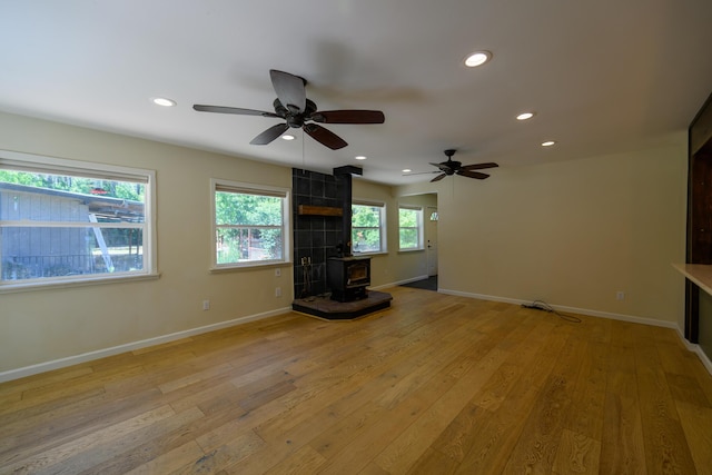290 Mountain View Dr, Lewiston, CA 96052 - unfurnished living room with a wood stove, light wood-style flooring, a ceiling fan, and recessed lighting