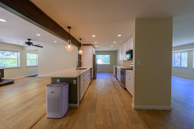 290 Mountain View Dr, Lewiston, CA 96052 - kitchen with appliances with stainless steel finishes, white cabinetry, light wood-style floors, healthy amount of natural light, and recessed lighting