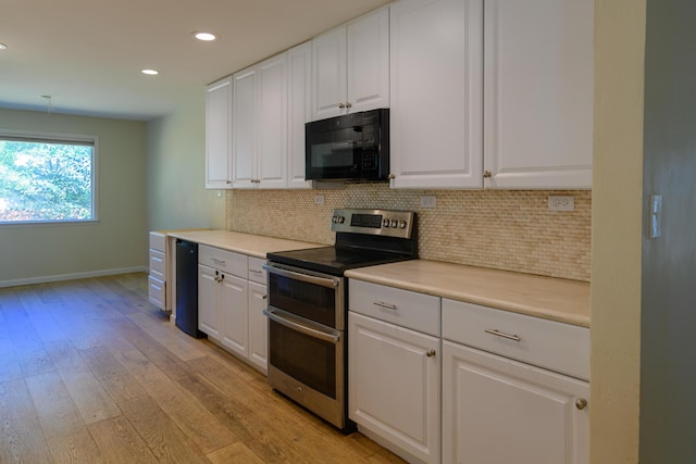 290 Mountain View Dr, Lewiston, CA 96052 - kitchen featuring black microwave, range with two ovens, backsplash, recessed lighting, and white cabinetry