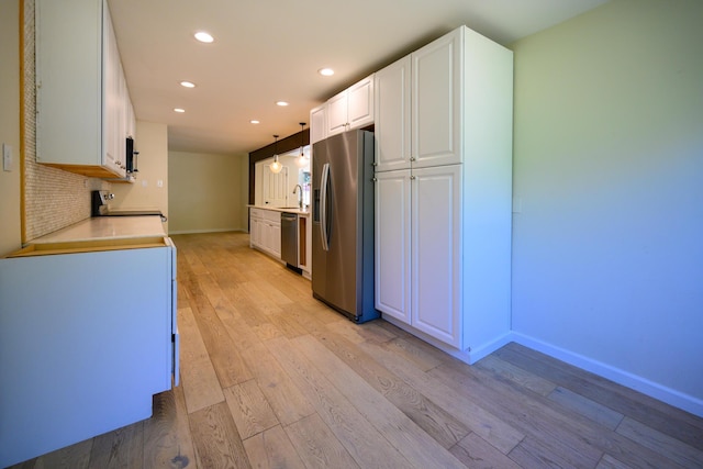 290 Mountain View Dr, Lewiston, CA 96052 - kitchen featuring appliances with stainless steel finishes, recessed lighting, light wood-style flooring, white cabinetry, and light countertops