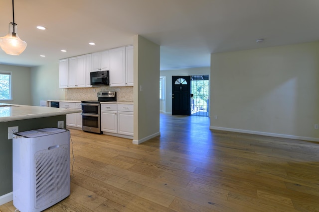 290 Mountain View Dr, Lewiston, CA 96052 - kitchen featuring range with two ovens, black microwave, light wood finished floors, backsplash, and recessed lighting