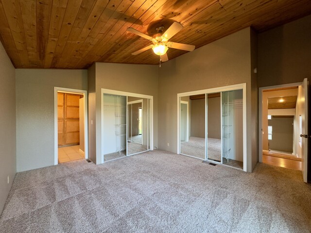 1020 Gibralter Rd, Redding, CA 96003 - unfurnished bedroom with lofted ceiling, wood ceiling, carpet floors, two closets, and ceiling fan