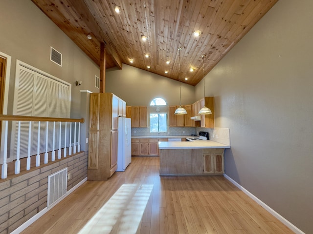 1020 Gibralter Rd, Redding, CA 96003 - kitchen with white appliances, light countertops, decorative backsplash, a peninsula, and light wood-style flooring