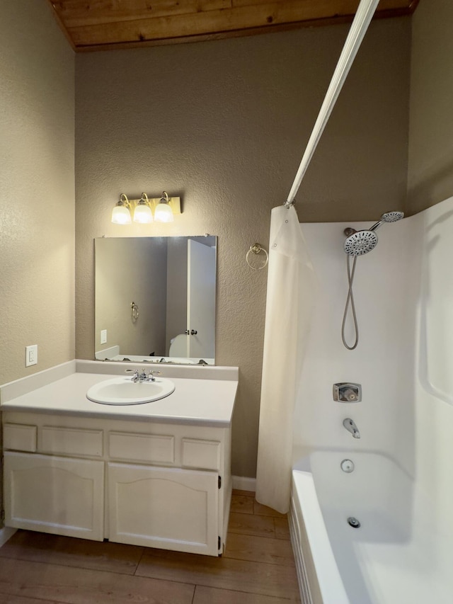 1020 Gibralter Rd, Redding, CA 96003 - full bathroom featuring wood finished floors, vanity, shower / bath combo with shower curtain, and a textured wall