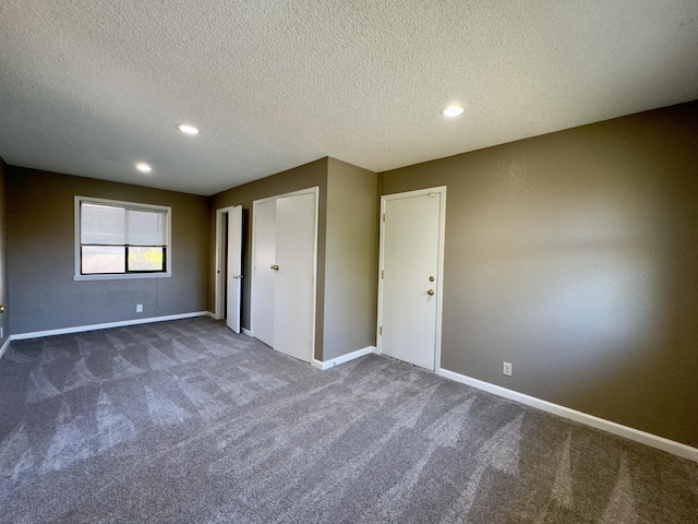 1020 Gibralter Rd, Redding, CA 96003 - unfurnished bedroom featuring dark colored carpet, a textured ceiling, and recessed lighting
