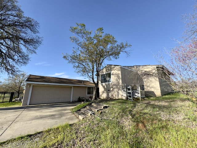 1020 Gibralter Rd, Redding, CA 96003 - view of front of property featuring an attached garage, concrete driveway, and stucco siding