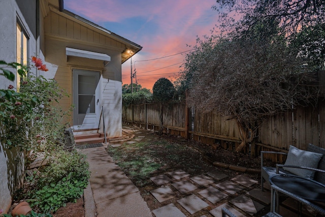 21552157 Butte St, Redding, CA 96003 - yard at dusk with entry steps, a fenced backyard, and a patio