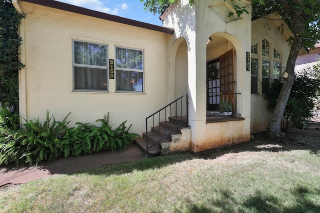 21552157 Butte St, Redding, CA 96003 - doorway to property with stucco siding and a lawn