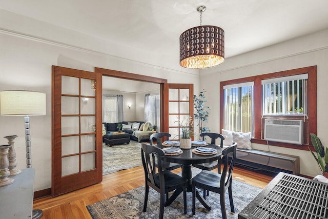 21552157 Butte St, Redding, CA 96003 - dining room featuring wood finished floors, a chandelier, and cooling unit