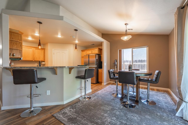 3388 Oak St, Anderson, CA 96007 - kitchen with freestanding refrigerator, wood finished floors, a kitchen breakfast bar, open shelves, and lofted ceiling