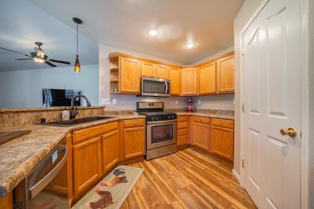 3388 Oak St, Anderson, CA 96007 - kitchen featuring appliances with stainless steel finishes, light wood-type flooring, decorative light fixtures, light countertops, and open shelves