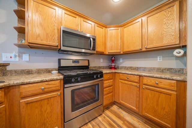 3388 Oak St, Anderson, CA 96007 - kitchen with stainless steel appliances, light wood finished floors, open shelves, and light countertops
