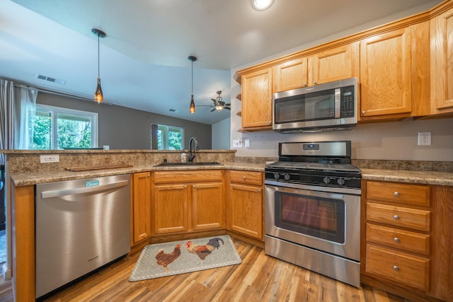 3388 Oak St, Anderson, CA 96007 - kitchen with appliances with stainless steel finishes, light wood-style floors, a ceiling fan, a peninsula, and pendant lighting