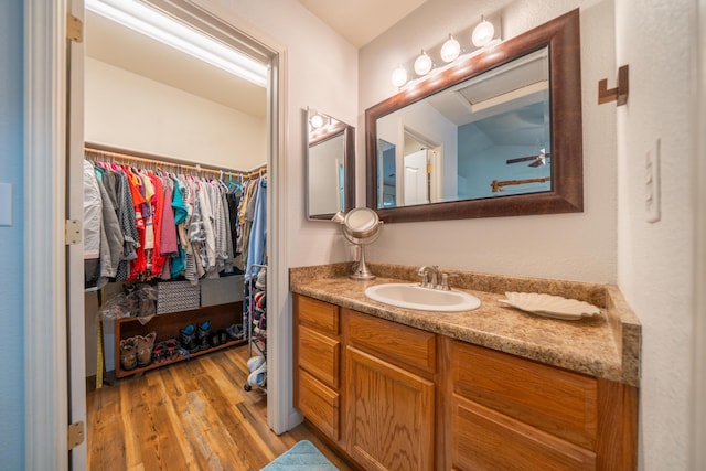 3388 Oak St, Anderson, CA 96007 - full bathroom featuring vanity, wood finished floors, and a spacious closet