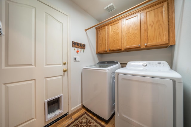 3388 Oak St, Anderson, CA 96007 - laundry area with washing machine and clothes dryer, cabinet space, and wood finished floors