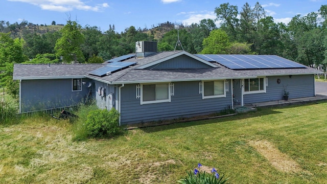 13354 Kings Way, Redding, CA 96003 - back of house with roof with shingles, roof mounted solar panels, and a lawn