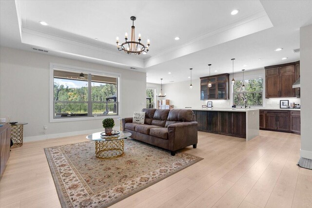 16520 Blarney Ln, Redding, CA 96001 - living area with a raised ceiling, a chandelier, plenty of natural light, crown molding, and recessed lighting