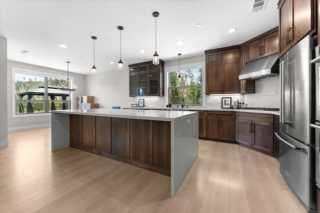 16520 Blarney Ln, Redding, CA 96001 - kitchen featuring stainless steel appliances, range hood, a large island, healthy amount of natural light, and recessed lighting