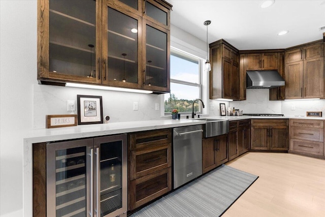 16520 Blarney Ln, Redding, CA 96001 - kitchen featuring stainless steel dishwasher, wall chimney range hood, wine cooler, light wood-type flooring, and decorative light fixtures