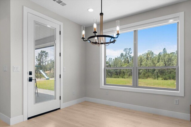 16520 Blarney Ln, Redding, CA 96001 - unfurnished dining area with a chandelier, healthy amount of natural light, wood finished floors, and recessed lighting