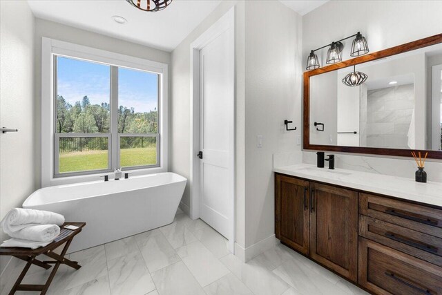 16520 Blarney Ln, Redding, CA 96001 - full bathroom featuring marble look tile flooring, a freestanding bath, vanity, and recessed lighting