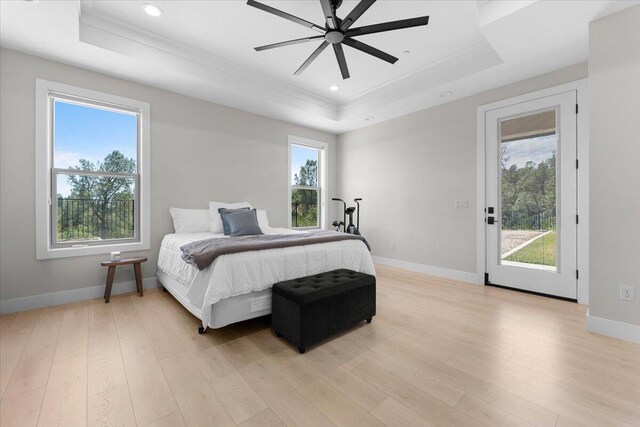 16520 Blarney Ln, Redding, CA 96001 - bedroom featuring a tray ceiling, crown molding, light wood finished floors, recessed lighting, and a ceiling fan