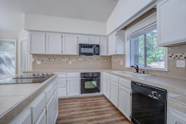 1633 Wee Burn Ct, Redding, CA 96003 - kitchen with black appliances, white cabinets, light countertops, and backsplash