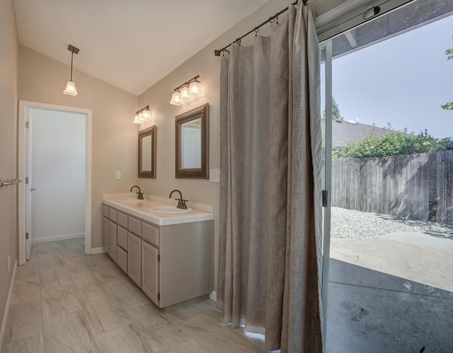 1633 Wee Burn Ct, Redding, CA 96003 - bathroom featuring vaulted ceiling, double vanity, and marble look tile flooring