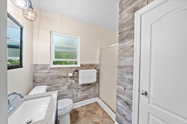 678 W St, Redding, CA 96001 - bathroom featuring plenty of natural light, stone tile flooring, a shower stall, wooden walls, and vanity