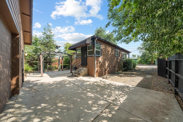 678 W St, Redding, CA 96001 - view of home's exterior featuring a patio, driveway, a carport, and entry steps