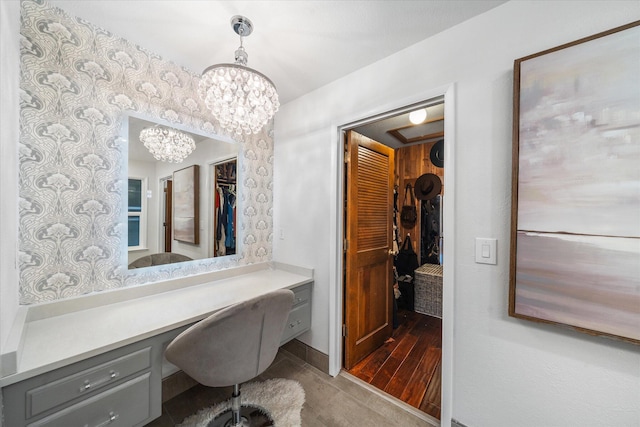 19396 Natalie Way, Redding, CA 96003 - office area featuring built in desk, a chandelier, and wood finished floors