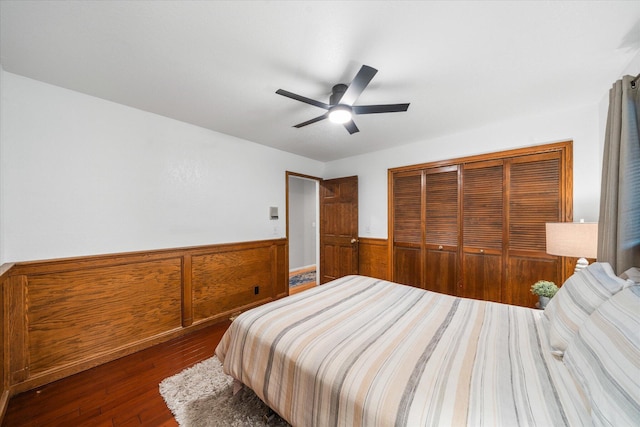 19396 Natalie Way, Redding, CA 96003 - bedroom featuring wainscoting, wood finished floors, a closet, ceiling fan, and wood walls
