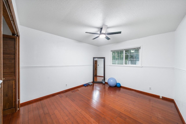 19396 Natalie Way, Redding, CA 96003 - workout area featuring a ceiling fan, wood-type flooring, and a textured ceiling