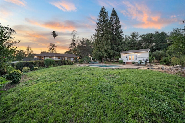 19396 Natalie Way, Redding, CA 96003 - yard at dusk with a patio area, an outbuilding, and an exterior structure