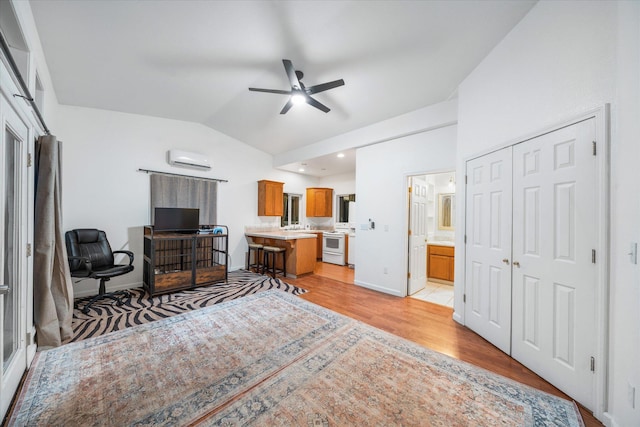 19396 Natalie Way, Redding, CA 96003 - bedroom featuring vaulted ceiling, light wood finished floors, a wall mounted air conditioner, ensuite bath, and a closet