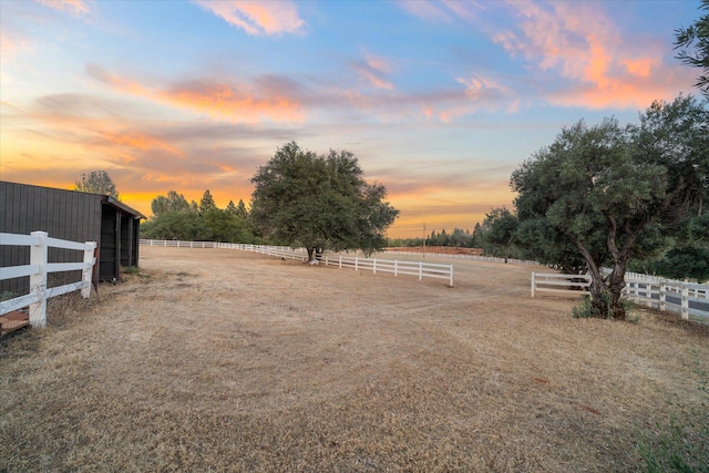19396 Natalie Way, Redding, CA 96003 - yard at dusk with a view of rural / pastoral area, an outdoor structure, and an exterior structure