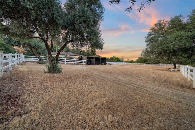 19396 Natalie Way, Redding, CA 96003 - yard at dusk with an exterior structure, an outbuilding, and a view of rural / pastoral area