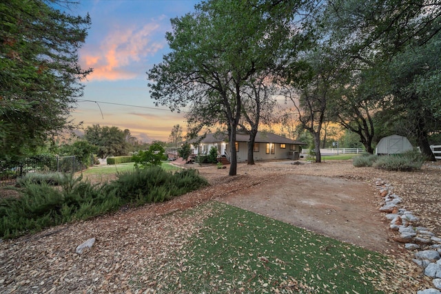 19396 Natalie Way, Redding, CA 96003 - yard at dusk featuring a shed